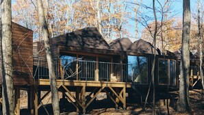 A cabin with a wooden deck and large windows, surrounded by trees. - SANU 2nd Home Karuizawa 2nd (Miyota)