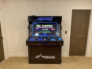 A retro arcade machine with a digital display, joystick controls, and a coin slot.