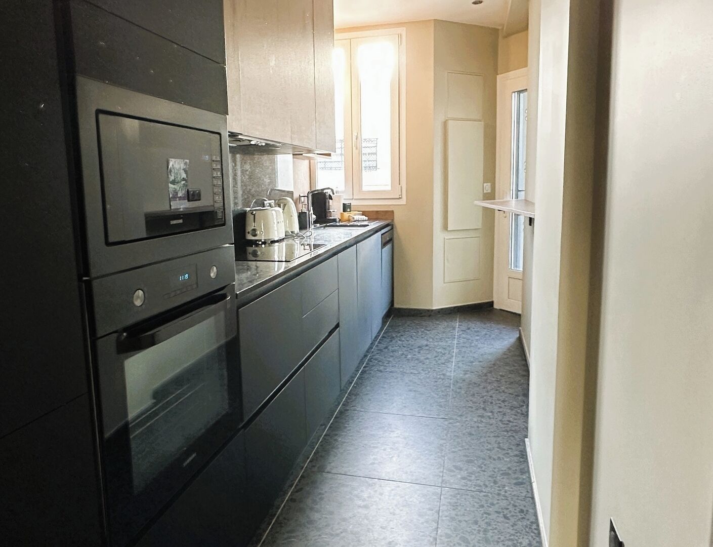 A compact kitchen with a microwave, toaster, and coffee maker.