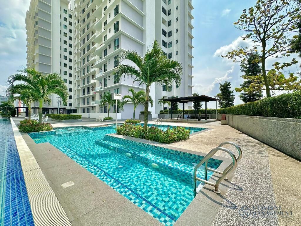 A swimming pool area with a modern building in the background.