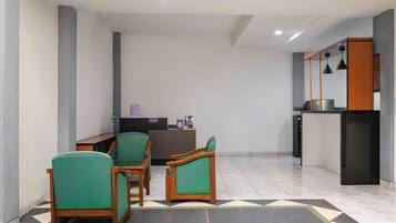 A reception area with a desk, chairs, and a counter.