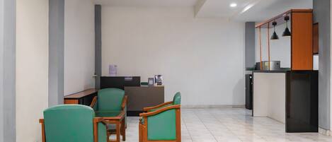A reception area with a desk, chairs, and a counter.
