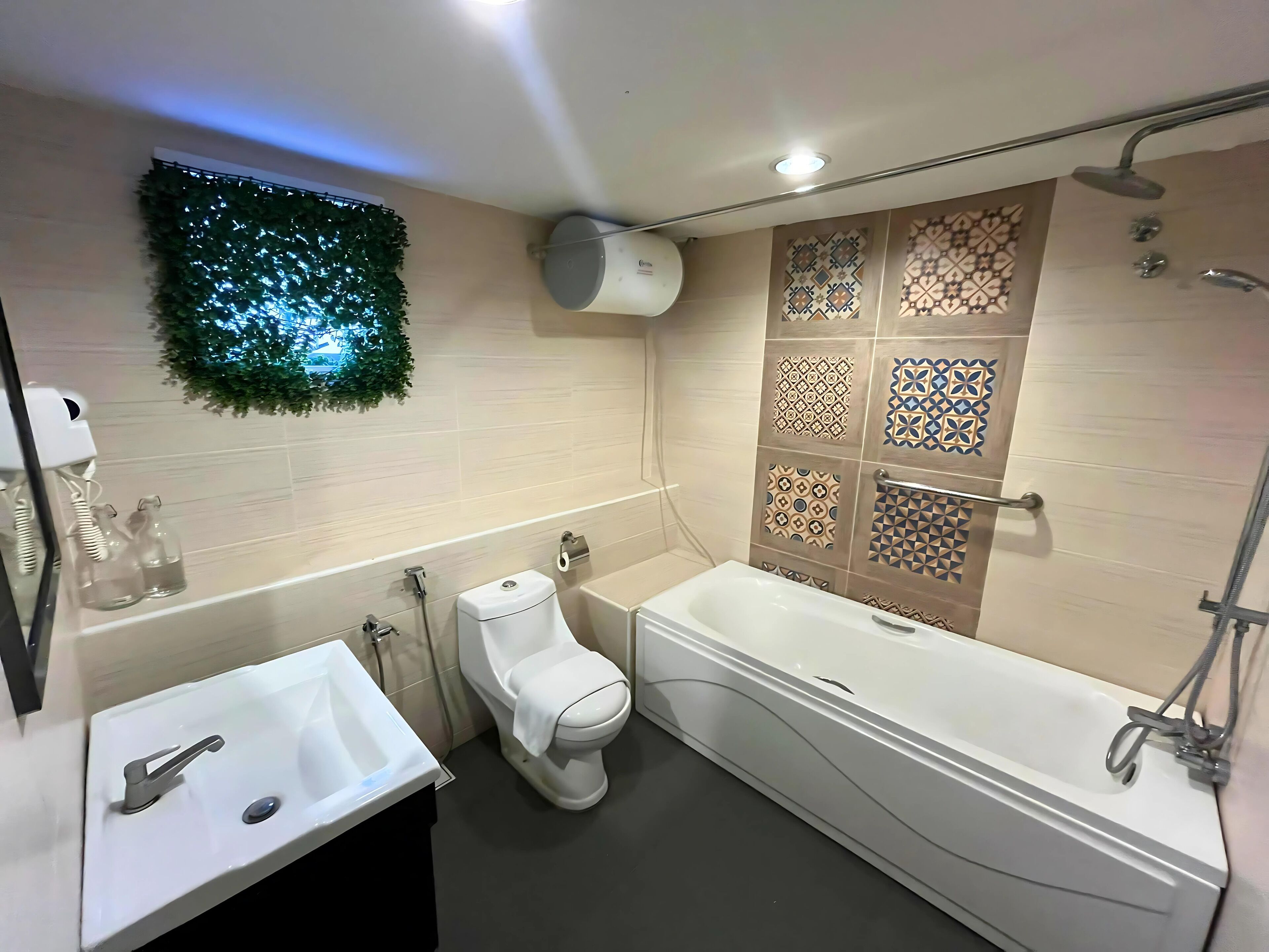 A modern bathroom with a white sink, toilet, and bathtub.
