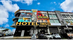 A hotel with a modern facade, multiple balconies, and a prominent 'OPEN NOW' sign. - Smile Hotel Shah Alam I-City (Shah Alam)