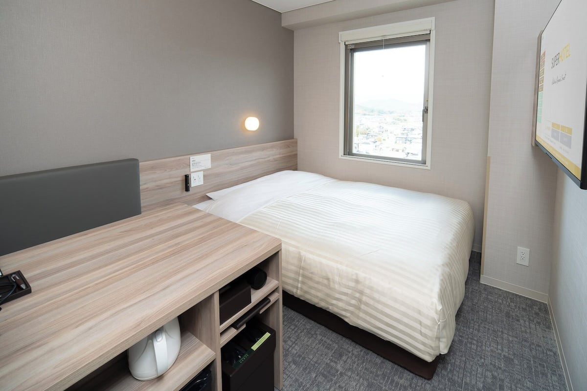 Desk, laptop workspace, blackout drapes, iron/ironing board