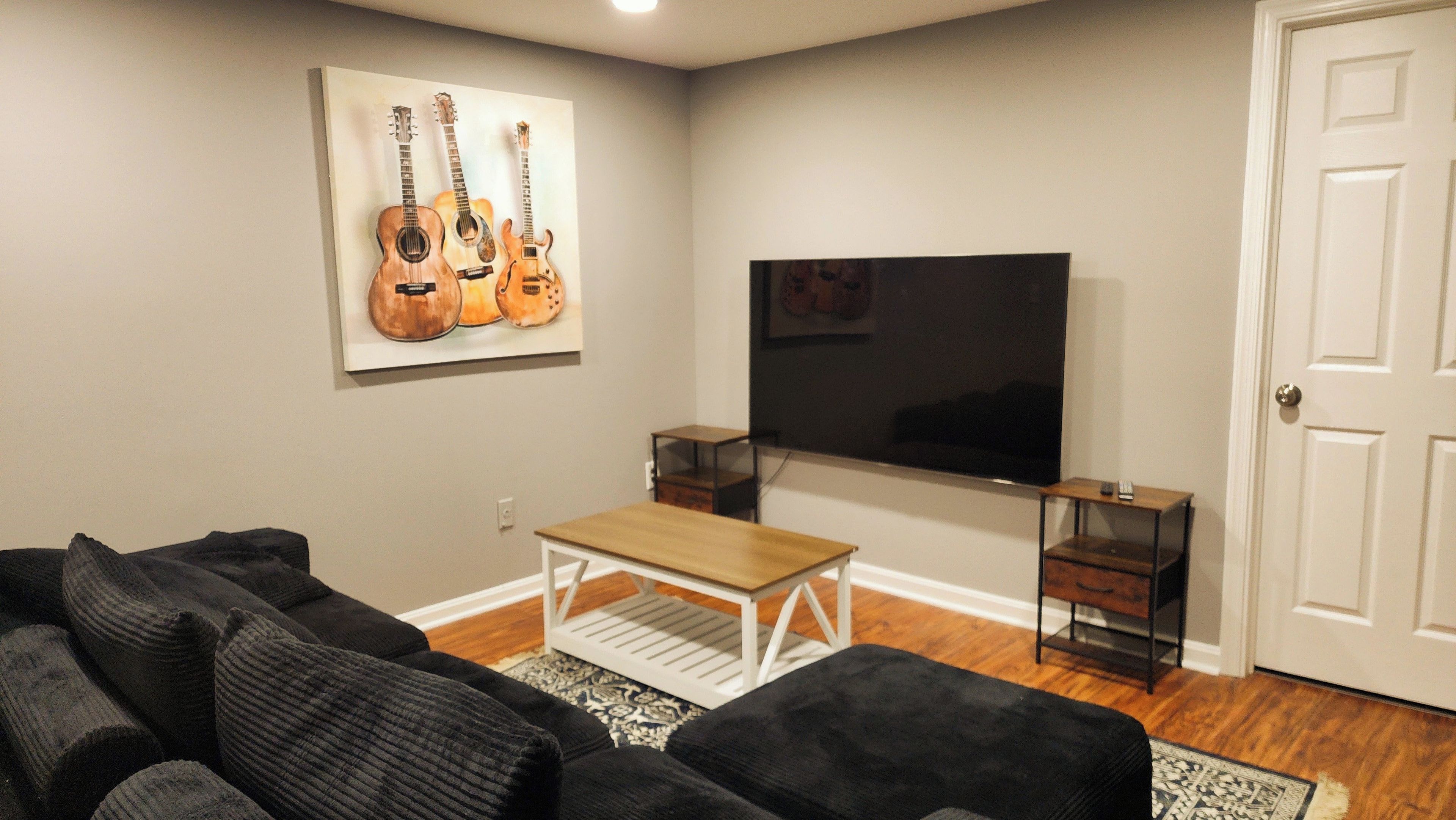 A living room with a TV, a coffee table, and a couch.