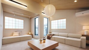 A modern living room with a sofa, a coffee table, and large windows providing natural light. - 2025/10Open! Lux Villa(132 m2) 6 min Shibuya/4m Ebisu (Ebisu, Shibuya-ku,)