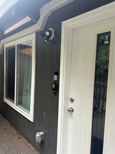 Julianna and Allan’s serene green belt view ADU with air conditioning unit.