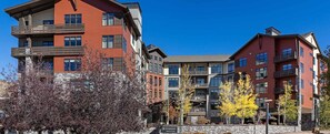 A multi-story hotel with balconies, a stone facade, and a sign indicating it's a Wyndham Resort at Avon.