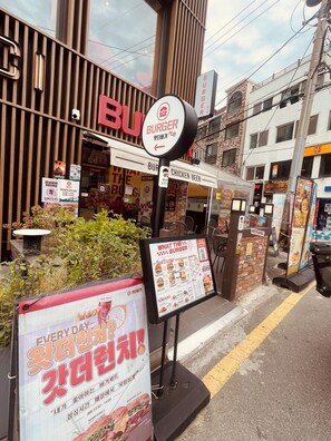 A Burger restaurant with a sign indicating a self-service bar and a chicken beer menu.