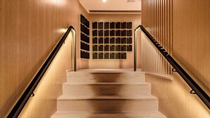 A wooden staircase with black handrails and a wall of mailboxes at the top. - Oootopia - Tai Kok Tsui (Kowloon)