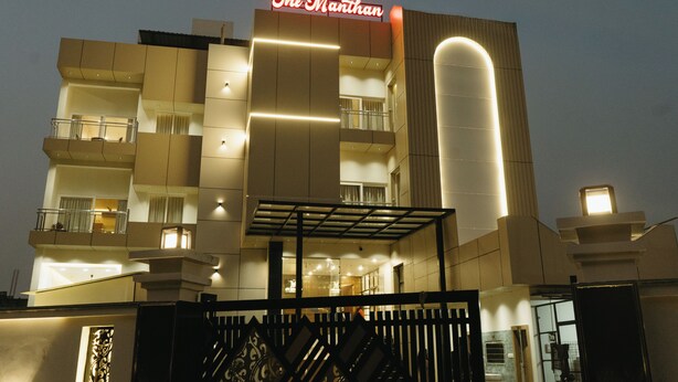 A multi-story hotel with a prominent sign reading "The Manthan." - The Manthan Hotel - City View (Faizabad)
