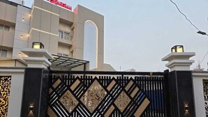 A gated entrance with a decorative metal gate featuring geometric patterns. - The Manthan Hotel - City View (Faizabad)