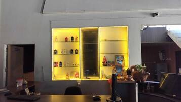 A reception desk with a glass display case containing various items.
