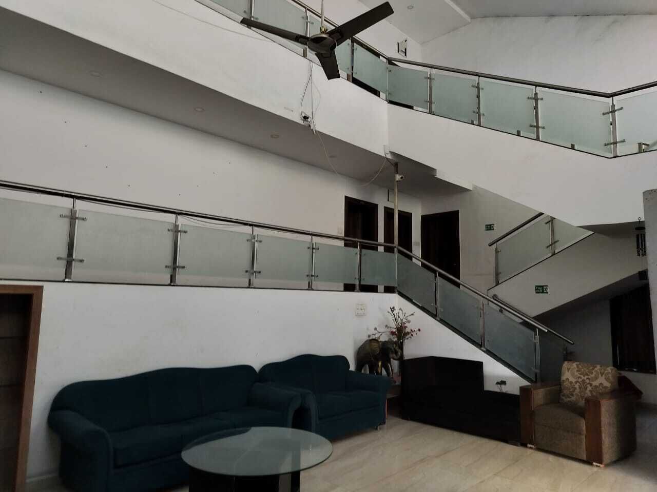 A modern interior with a staircase, a sofa, and a small table.