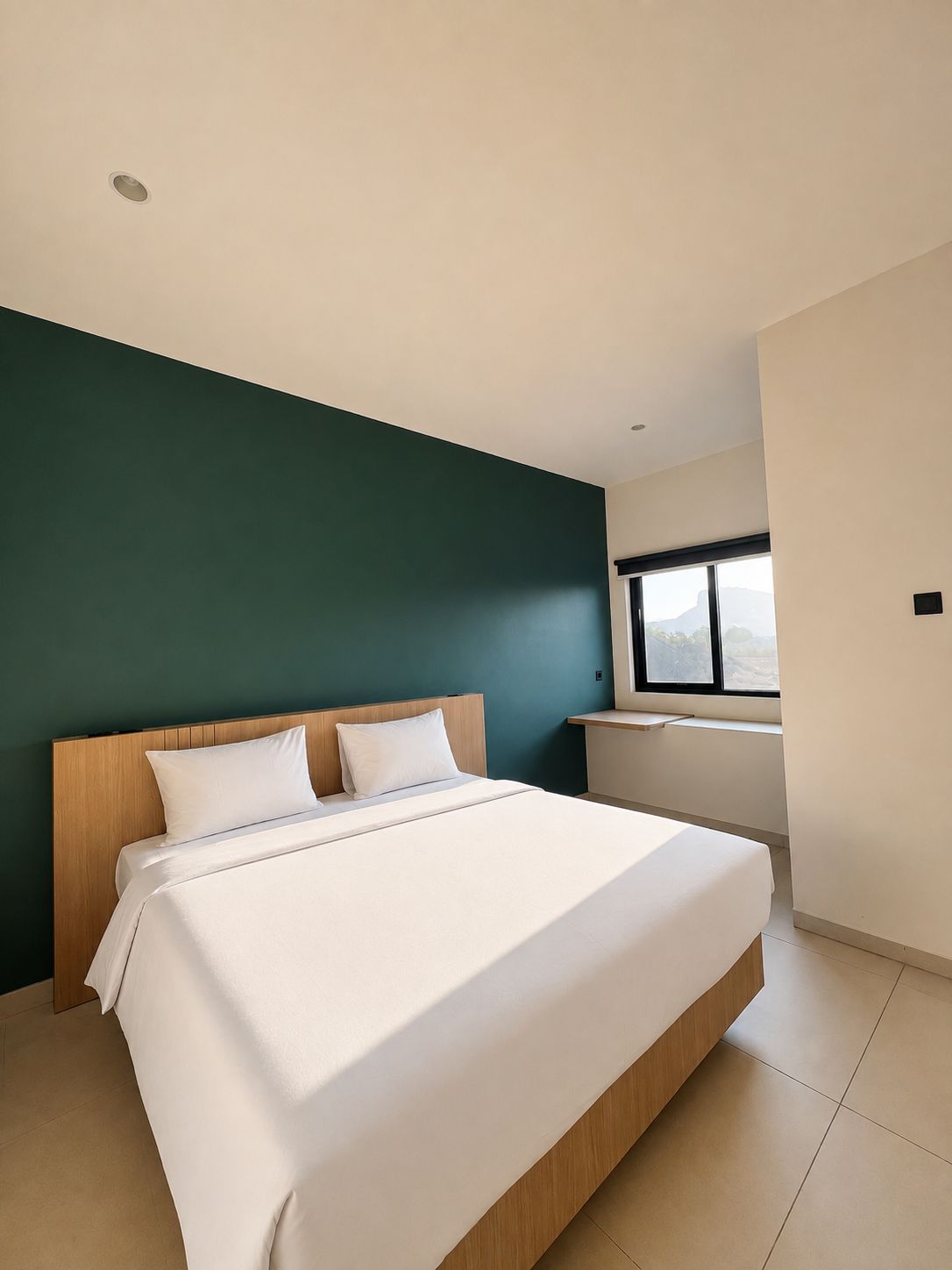 A modern bedroom with a large bed, a wooden headboard, and a window providing a view.