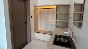 Un baño moderno con lavamanos integrado, un espejo y un mueble de tocador de madera.