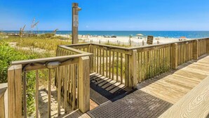 A wooden boardwalk leading to a beach with a clear view of the ocean. - Bluewater 103 (Orange Beach)