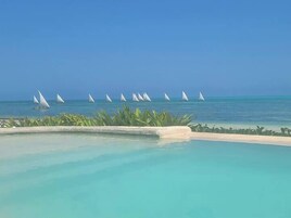 Una piscina al aire libre, camas de piscina gratis, sombrillas