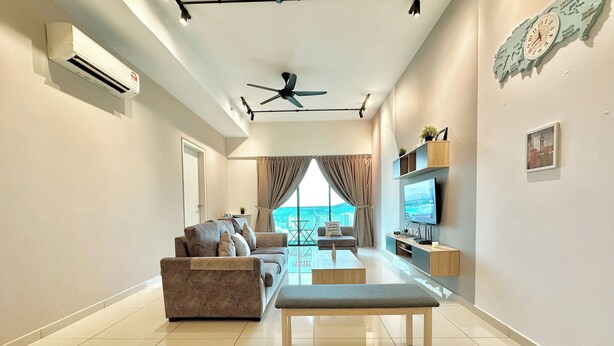 A modern living room with a sofa, a coffee table, and a TV. There is a ceiling fan, a wall-mounted TV, and a window with curtains. - Melaka Ong Kim Wee Residence by Stayrene (Malacca City)