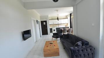 Standard Apartment, Balcony | Living area | 27-inch TV with satellite channels