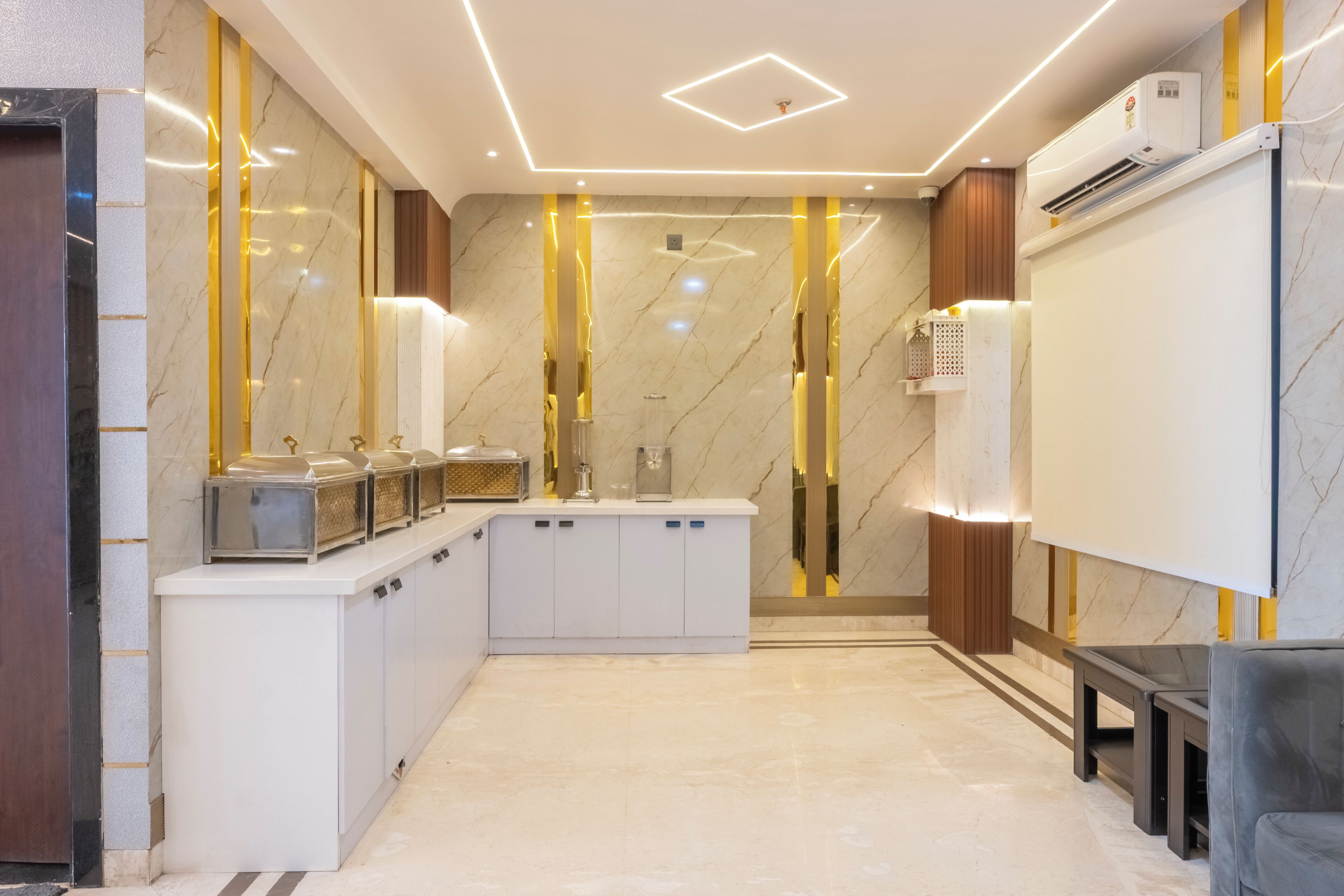 A modern bathroom with a marble floor, a sink with a mirror, and a shower area.