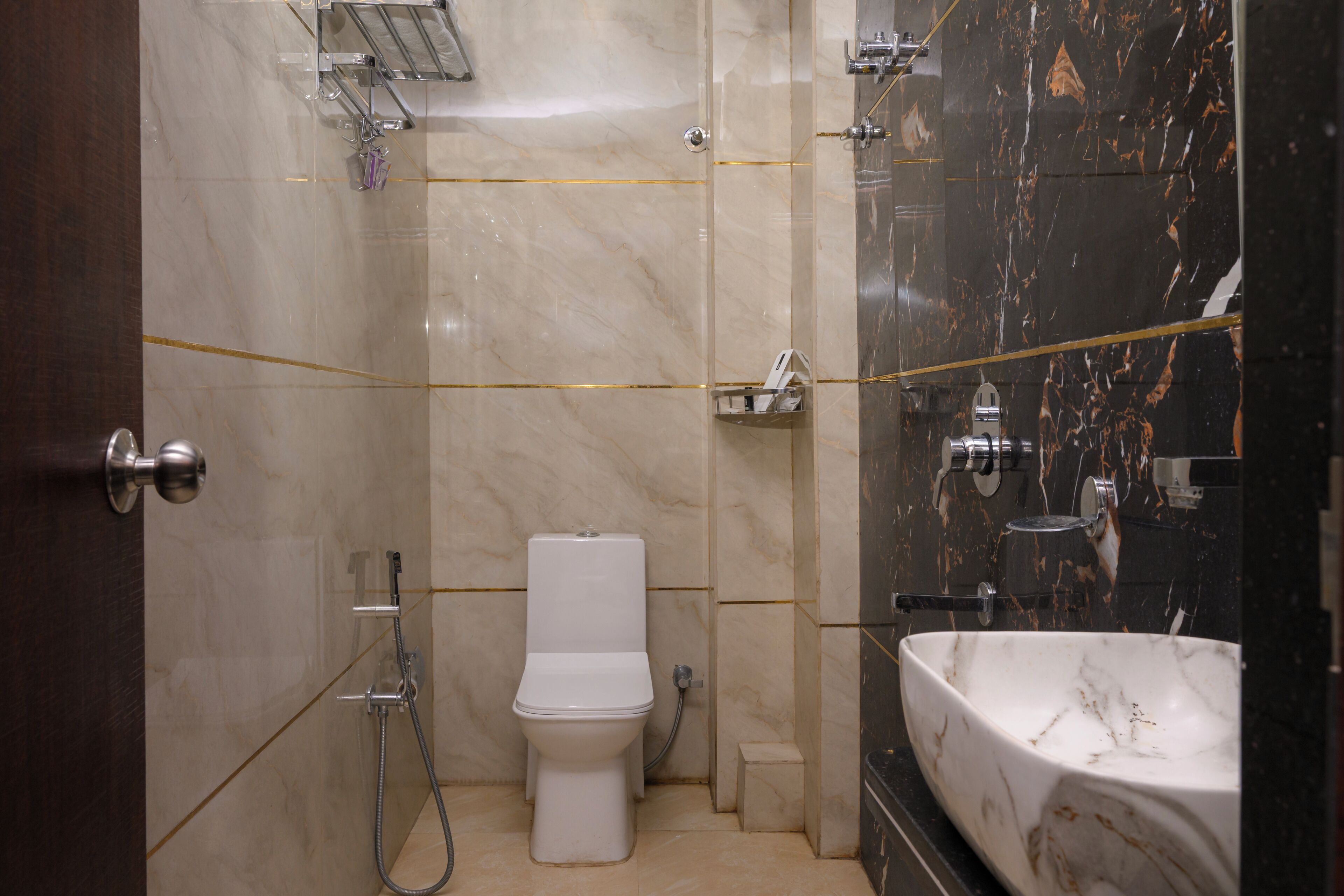 A bathroom with a toilet, a shower, and a sink.