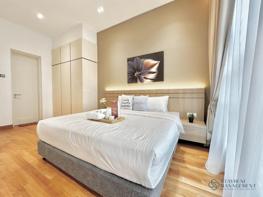 A modern hotel room with a large bed, a wooden headboard, a wall-mounted artwork, and a bedside table with a vase.