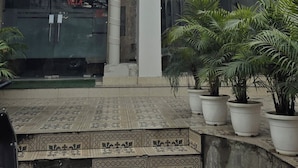 A building with a sign for "Luxury Rooms | Golden Pearls by MP Home Stay Villa" and a gated entrance. - Golden Pearl Infront Golden Temple Gate (Amritsar)