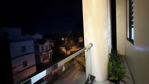 A balcony with a view of a residential area at night. - Bacnam Quang Ngai Hotel (Nghia Lo)