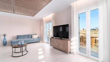 Deluxe Villa, Patio, Pool View | Living area | TV