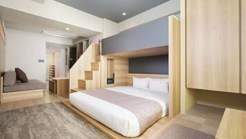 A modern bedroom with a bed, built-in wardrobe, and a staircase.