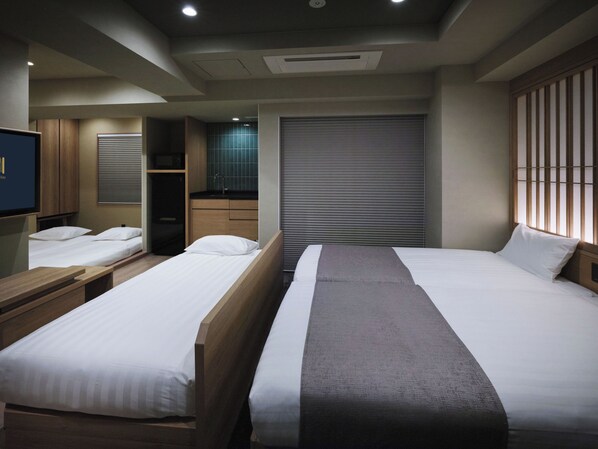 A hotel room with two single beds, a TV, a minibar, and a sliding door closet. - Premium Apart MONday HAMAMATSUCHO Station (Tokyo)