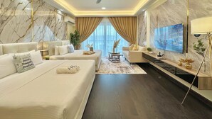 A modern hotel room with a large bed, a sofa, a TV, and a ceiling fan. - R&F Princess Cove Phase 2 by Stayrene (Johor Bahru)