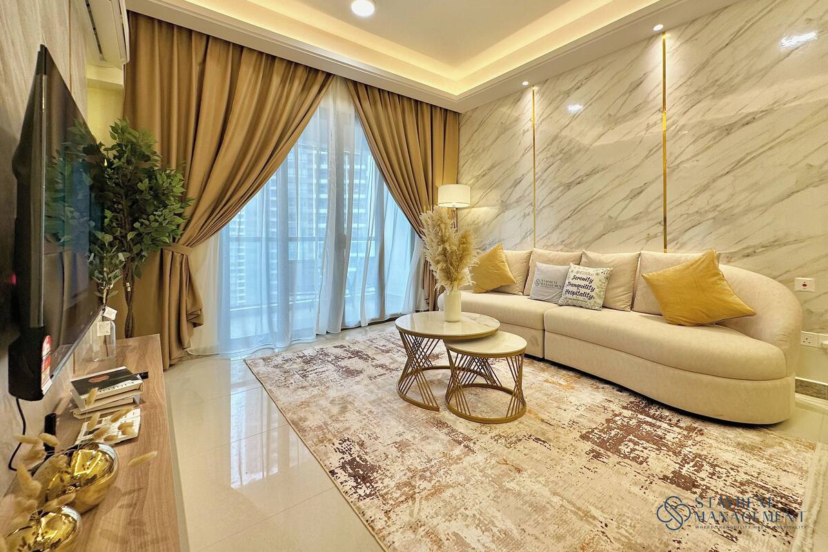 A modern living room with a sofa, a coffee table, and a TV.