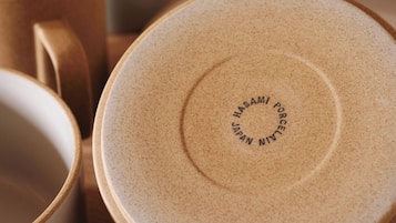 A close-up of ceramic tableware with embossed text.