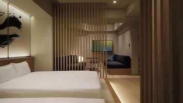 A modern hotel room with two beds, a TV, a sofa, and a sliding partition.