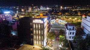 A building with a sign reading "Khaosan Song Nole" and a view of a cityscape at night. - Nile Hotel Phu Yen  (Tuy Hoa)