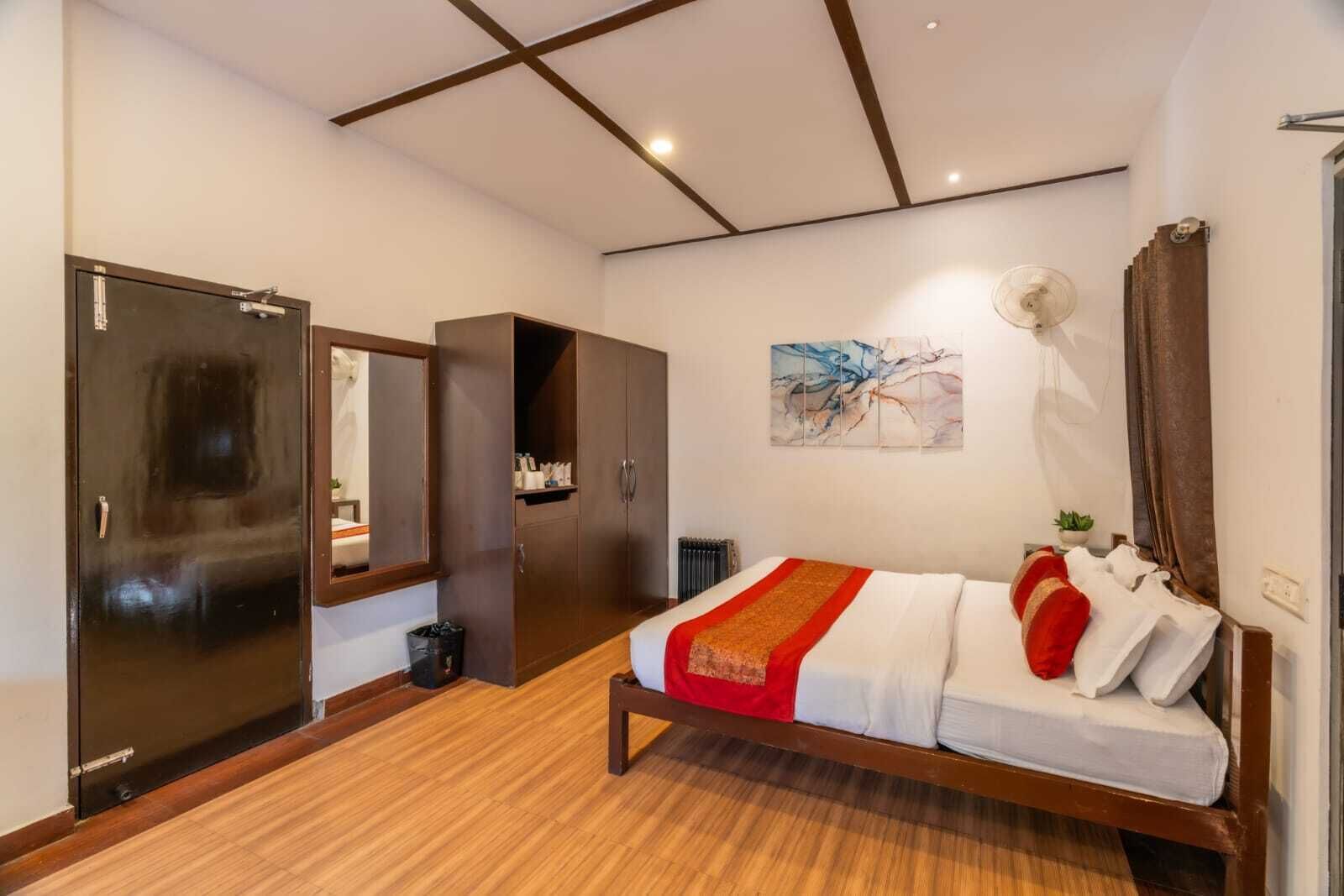 A bedroom with a bed, wardrobe, and a radiator.
