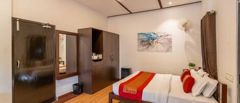 A bedroom with a bed, wardrobe, and a radiator.