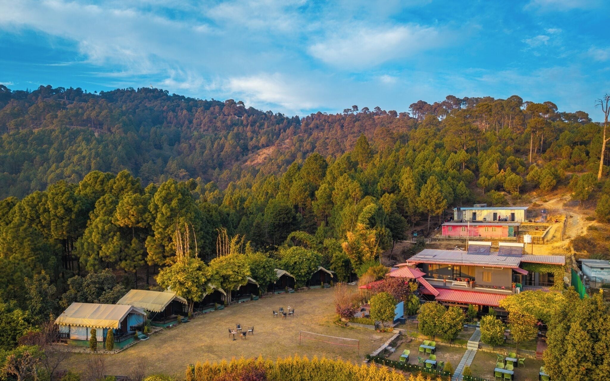 A resort with multiple cabins, a pool area, and a dining space.