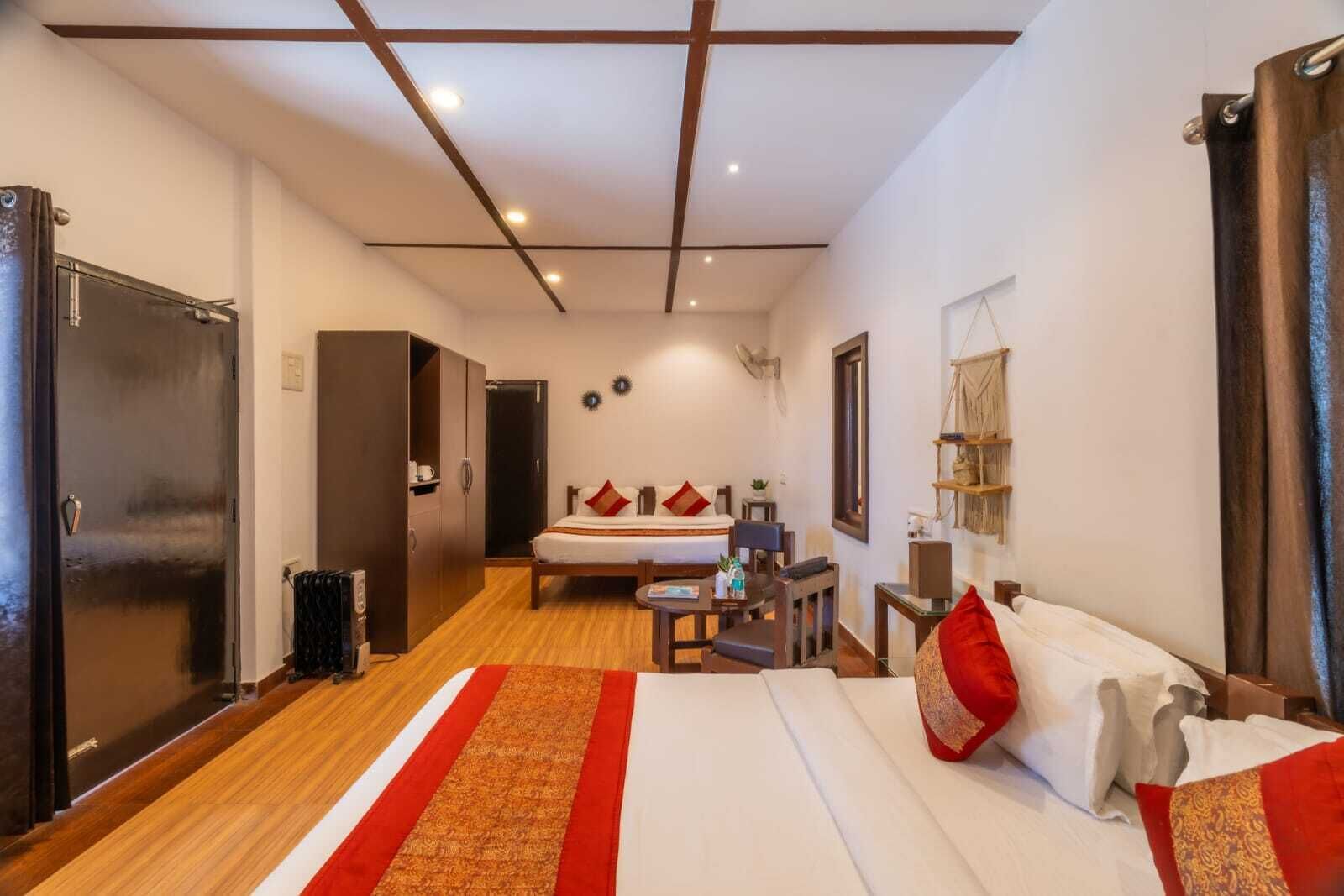 A hotel room with a bed, a desk, a chair, a wardrobe, and a bathroom door.