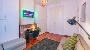 A modern living room with a fireplace, a desk, and a comfortable seating area.