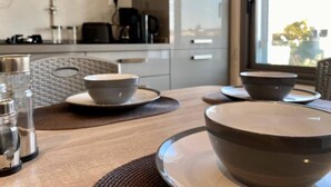 A modern kitchen with a marble backsplash, a coffee machine, and a view of the outdoors through a window. - Cozy stay with balcony view in La Marsa (Marsa)