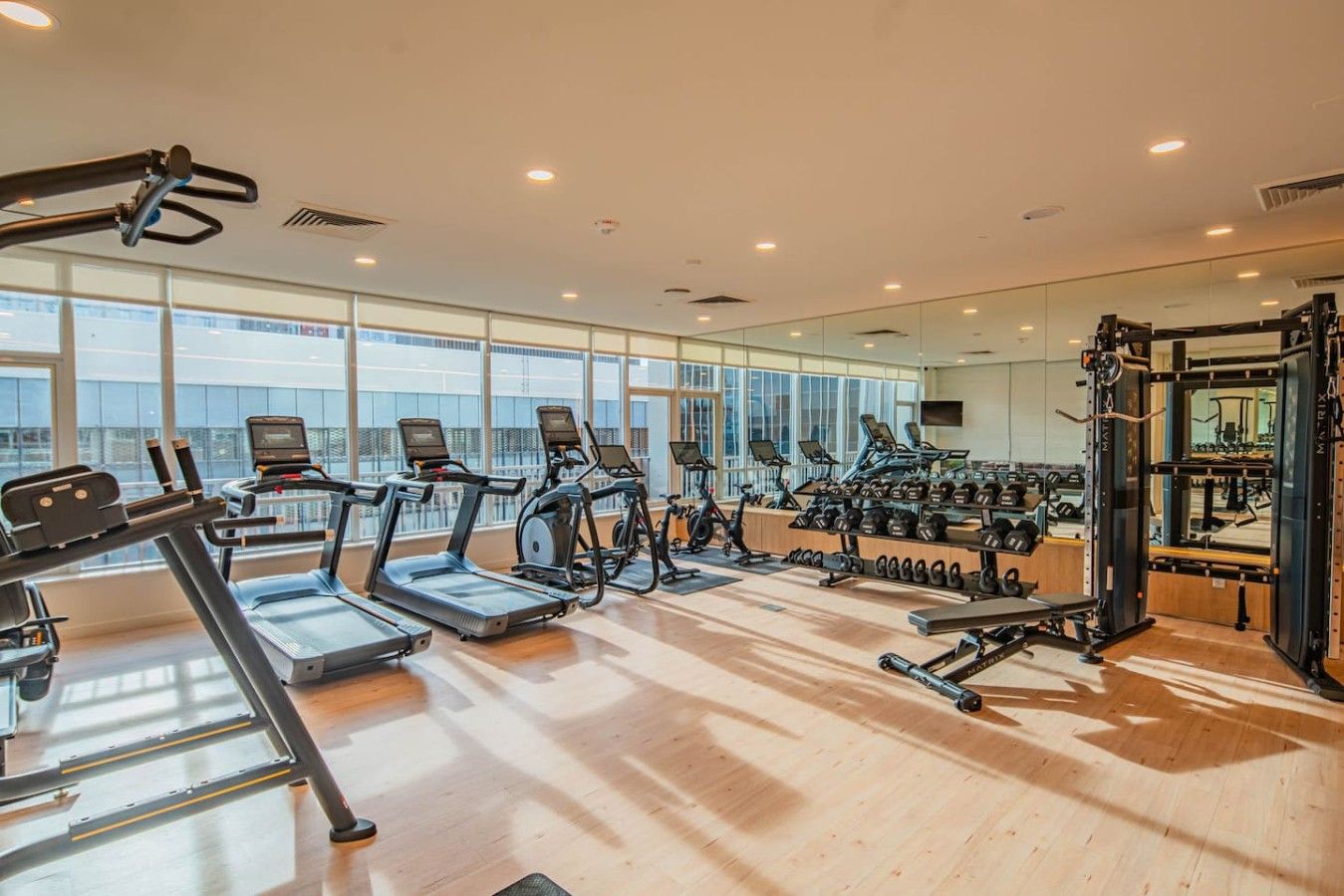 A gym with treadmills, stationary bikes, and weightlifting equipment.