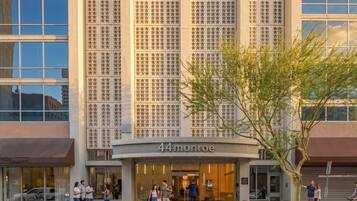 A modern building with a large glass facade and the name '44 monroe' displayed prominently at the entrance.