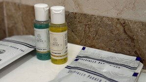 A bathroom counter with two bottles of City Group products, a shower gel and a shampoo, and two packages of City Group bath bombs. - CITY GRAND (Puri)