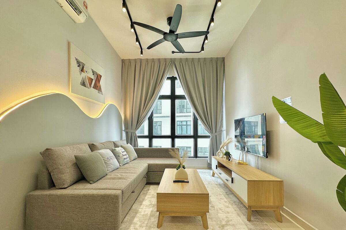 A modern living room with a sofa, coffee table, and TV.