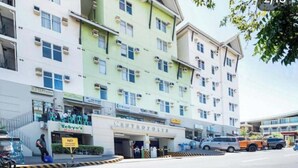 A multi-story hotel with a central entrance labeled "CENTROPOLIS." - Cozy 1-bedroom condo with AC in charming Muntinlupa (Muntinlupa)