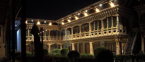 A historic building with ornate architecture, including a balcony and a staircase.
